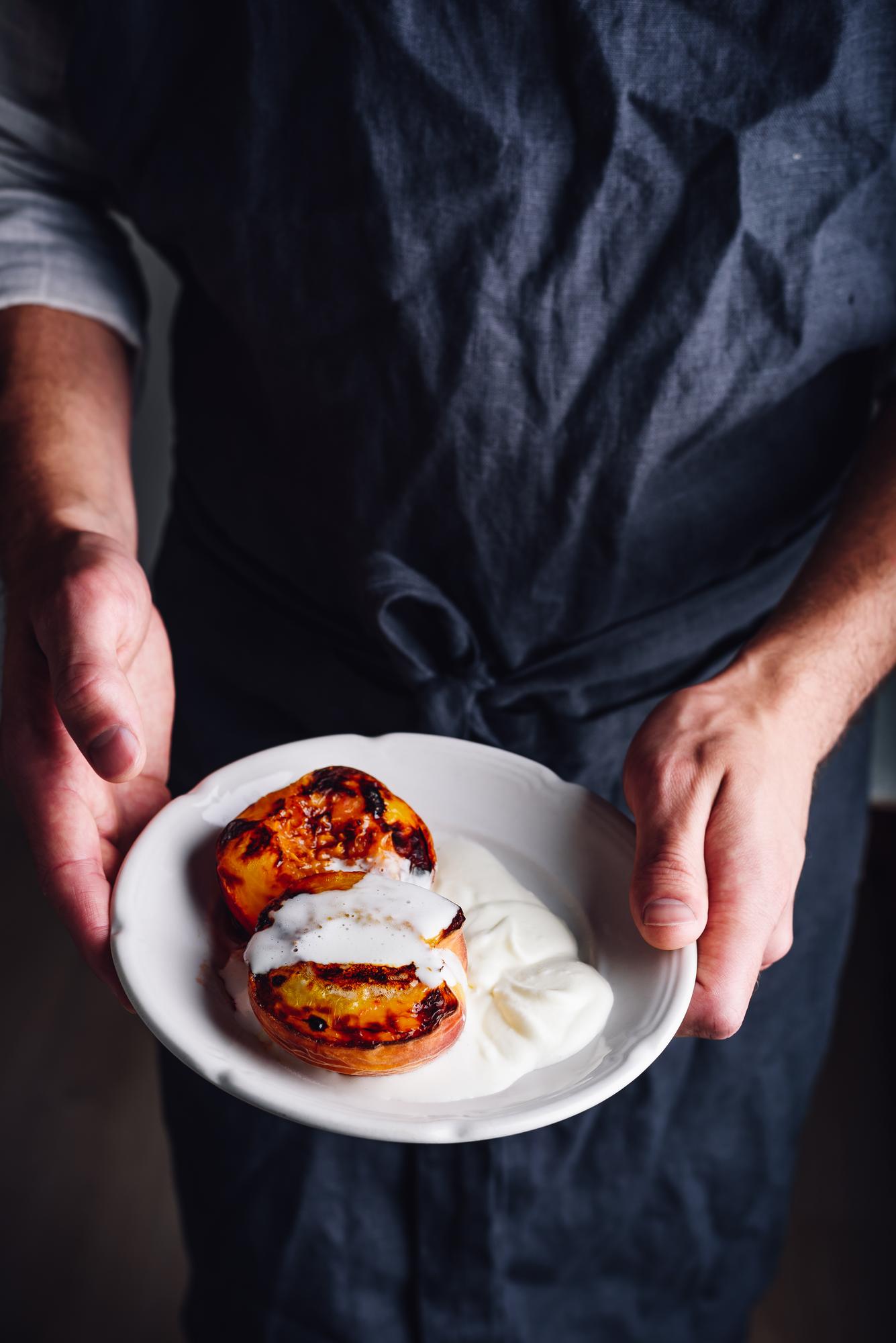 Chef arranging plated dish in elegant kitchen